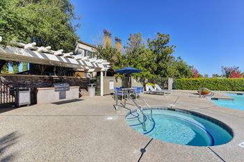 Pool and spa area where BBQ island is located.  Grilling station is equipped with gas bbq and counters for preparing food.at Folsom Ranch, Folsom, CA, 95630